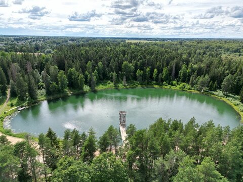 Aerial shot of Lake Vanamoisa surrounded by a forest of high trees in Torva, Estonia