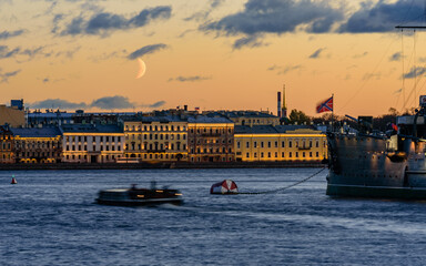 Cityscape of Saint Petersburg, Russia. Neva river, Aurora ship and buildings with evening lighting, beautiful night view