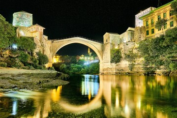 Old bridge under a clear starry night sky in Mostar, Bosnia and Herzegovina