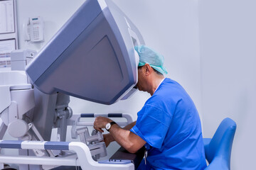 surgeon performing robotic surgery with robotic device. Medical operation involving robot....