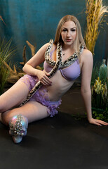 Fototapeta premium portrait of a woman holding a snake 