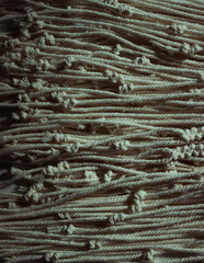 Ropes background. Creative image. Handmade macrame pattern a fragment of a boho style wall panel.