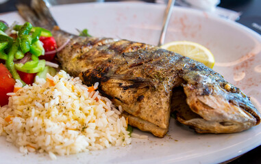 Greek grilled sea bream with rice and salad from a Greece local resturant