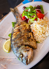 Greek grilled sea bream with rice and salad from a Greece local resturant