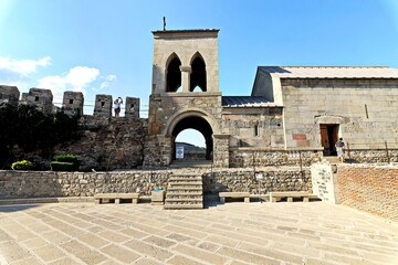 Fototapeta premium Various views of an ancient fortress, walls, buildings and structures on background of the blue sky. Khertvisi Fortress, Georgia. 