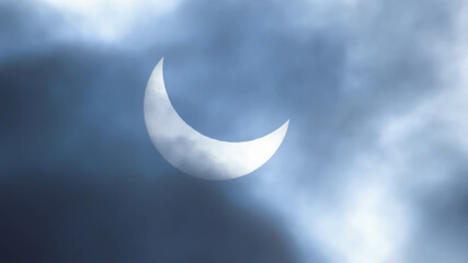 Plakat Image of a partial solar eclipse through veil clouds