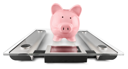 Piggy bank on scales isolated on white