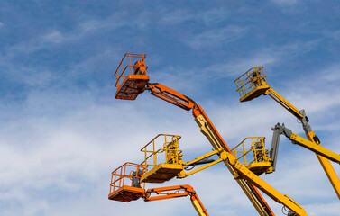 building cranes and elevators for building construction against blue sky