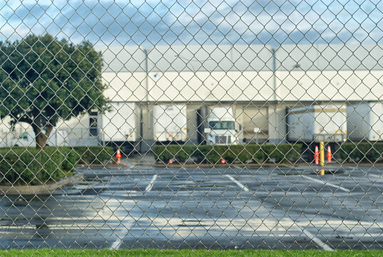 Loading dock behind a chain link fence.