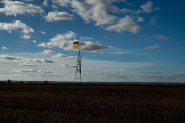 Ukrainian flag waving in wind and sunlight. Flag of Ukraine on blue sky background. National symbol of freedom and independence.