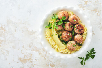 Swedish meatballs in cream sauce, potatoes and lingonberry sauce in bowl on slate, stone or concrete backgrounds. Swedish cuisine. Delicious creamy mashed potatoes. Top view.