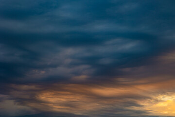 Naklejka na ściany i meble Dramatic clouds at sunrise. Weather background photo