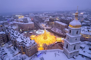 Muurstickers Christmas tree with lights outdoors at night in Kiev. Sophia Cathedral on background. © Ryzhkov Oleksandr