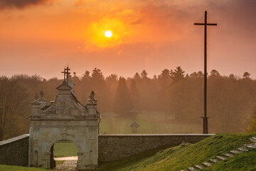 Foggy sunrise on the Bald Mountain peak with baroque style gate of former Benedictine monastery...