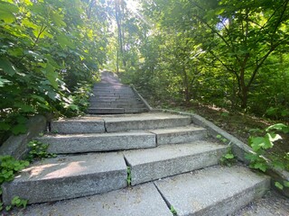 Landscape of long winding stairs in the town, long stone steps iin a park leading up a hill