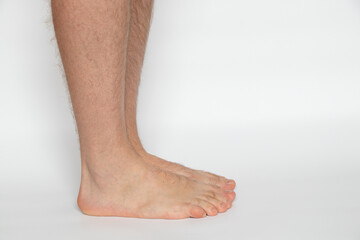Men's legs on a white background close-up, health