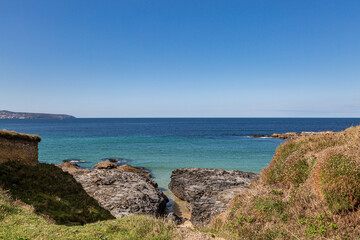 A view out over the ocean at Godrevy on the Cornish coast, with a blue sky overhead