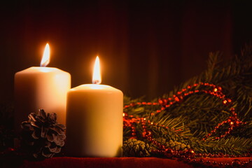 Christmas candles and ornaments over dark background with lights