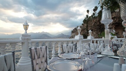 stylish dining area near the sea and under cloudy sky