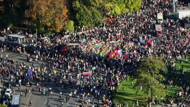 Crowd of people with Iranian flags on protest rally on square. Aerial view of Iranian demonstration. Berlin, Germany