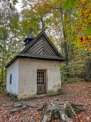Fototapeta na wymiar Swieta Katarzyna, Poland - October 16, 2022: An old chapel on the edge of a fir forest in the village of Swieta Katarzyna (St. Catherine) where Stefan Żeromski, a famous Polish writer, prayed.