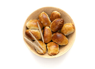 Homemade pies in bamboo basket on white background. Cooking concept. Close-up