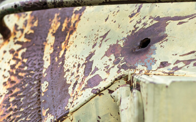 Russian combat vehicle, with holes in the armor. Destroyed military armored vehicles, disabled, blown up and destroyed. Armor metal background with bullet holes. Hole from cumulative penetration.