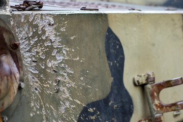 Hole or hole, armor deformation from a projectile close-up. Damaged armor of a Russian armored...