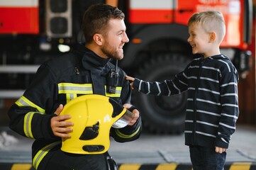Fototapeta premium Protect people from dangerous with brave heart.Hero in fireman with uniform safe children from burn smoke