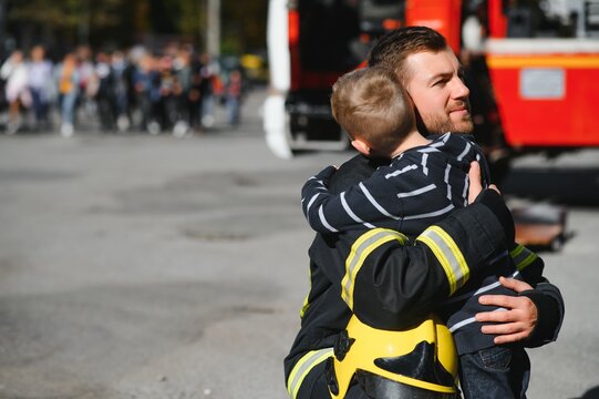 Firefighter holding child boy to save him in fire and smoke,Firemen rescue the boys from fire