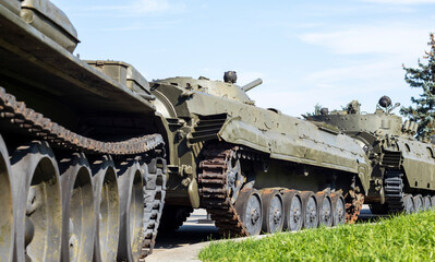 Fototapeta na wymiar A column of armored vehicles and tanks. National Armed Forces. Military equipment and troops. War in Ukraine. Building or building combat vehicles. Armored weapons. means of the armed forces.