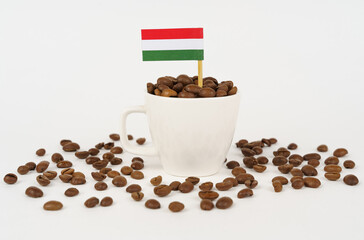 The flag of Hungary sticks out of a cup of roasted coffee beans.