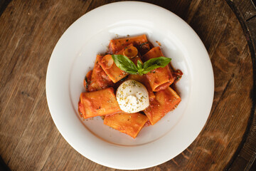 Appetizing Italian pasta with cheese on a dark wooden background