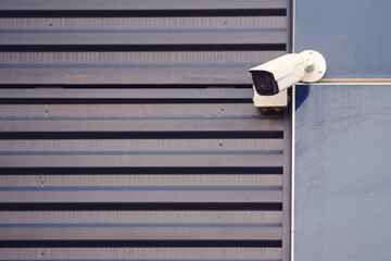 Surveillance camera at the garage door on the facade of the building. cctv camera at the entrance...