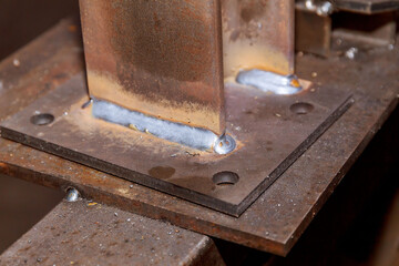 Weld joint joining two metal parts. welding seam. on steel sheet metal.