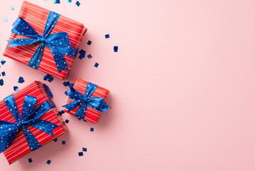 Forth of July concept. Top view vertical photo of present boxes with bows and confetti on isolated...