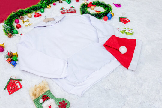 Blank white Hoodie Mockup Image With Christmas Themed Decorations Around it