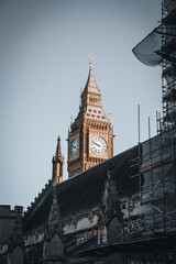 Bright Big Ben between other buildings