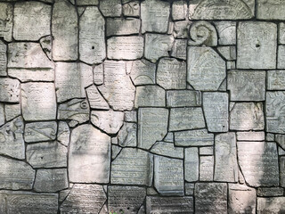 Ruined jewish tombstones matzevah on a wall in the jewish cemetery Remah Synagogue in Kazimierz district of Krakow, Poland © Antonio