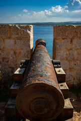 Fototapeta na wymiar old, rusted cannon in the fortress on comino island in malta