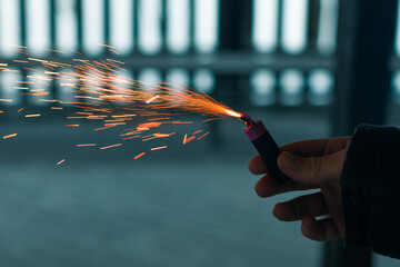 Burning Firecracker with Sparks. Guy Holding a Petard in a Hand. Loud and Dangerous New Year's...