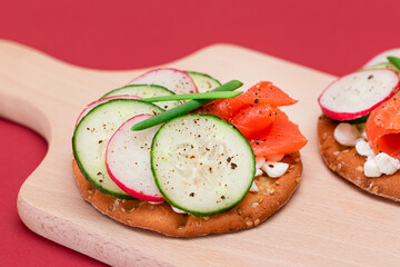 Crispy Cracker Sandwiches with Fresh Salmon, Cucumber, Radish, Cottage Cheese and Green Onions. Easy Breakfast. Quick and Healthy Sandwiches. Crispbread with Tasty Filling. Healthy Dietary Snack