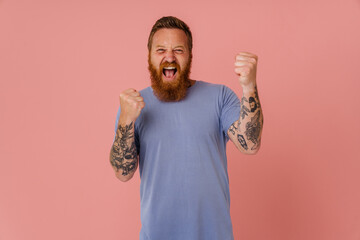 Ginger white man screaming and making winner gesture