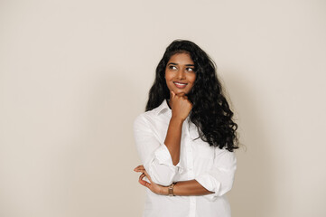 Young brunette indian woman smiling and looking aside