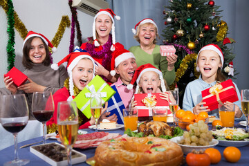 Portrait of happy family who is satisfied of gifts in time celebration New Year at home