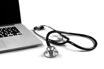 Modern laptop and stethoscope isolated on white background