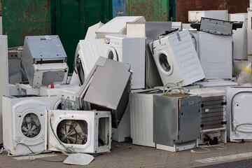 Collected and awaiting for the disposal of electronic-waste - refrigerators, washing machines and others. Close-up - obrazy, fototapety, plakaty