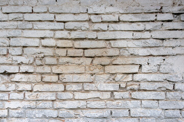 Texture of a weathered white brick wall.