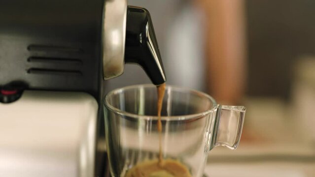 4k video of coffee coming out of an espresso machine