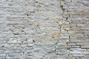 Texture of a weathered white brick wall.